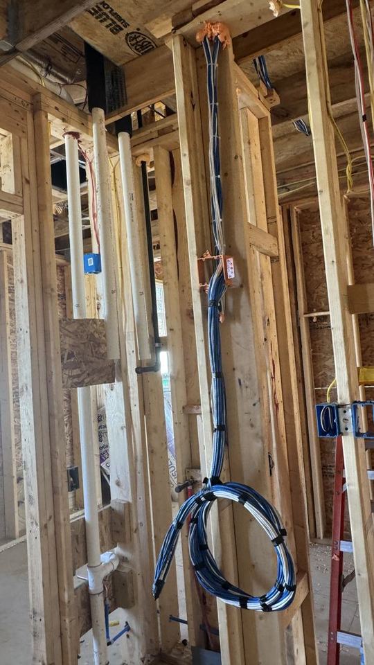 Cat6 structured cabling run through open wall framing on a new-construction job