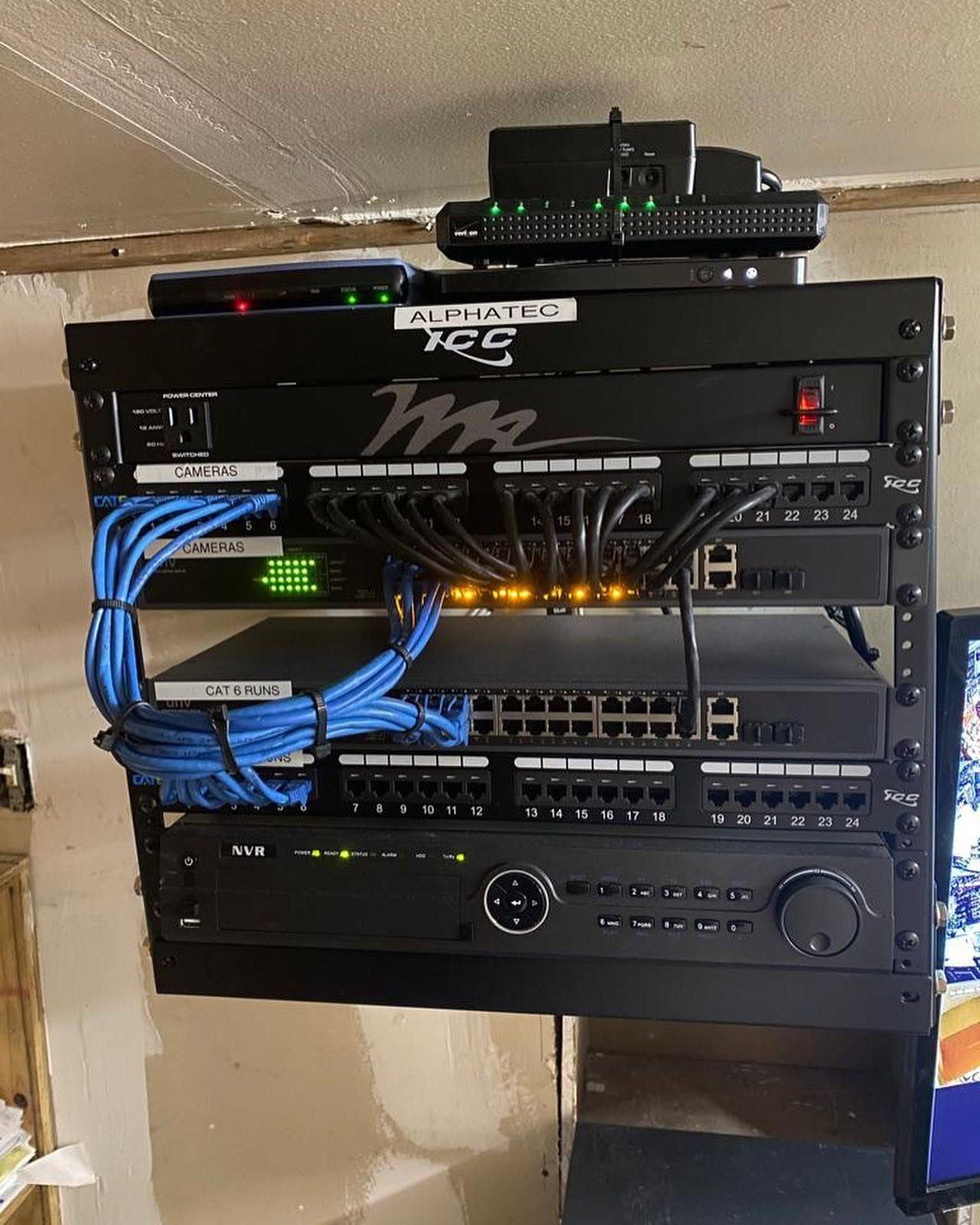 Alphatec-installed network rack with patch panels and an NVR for a camera system